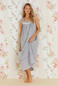 A lady wearing grey sleeveless cotton nightgown with chambray floral print.