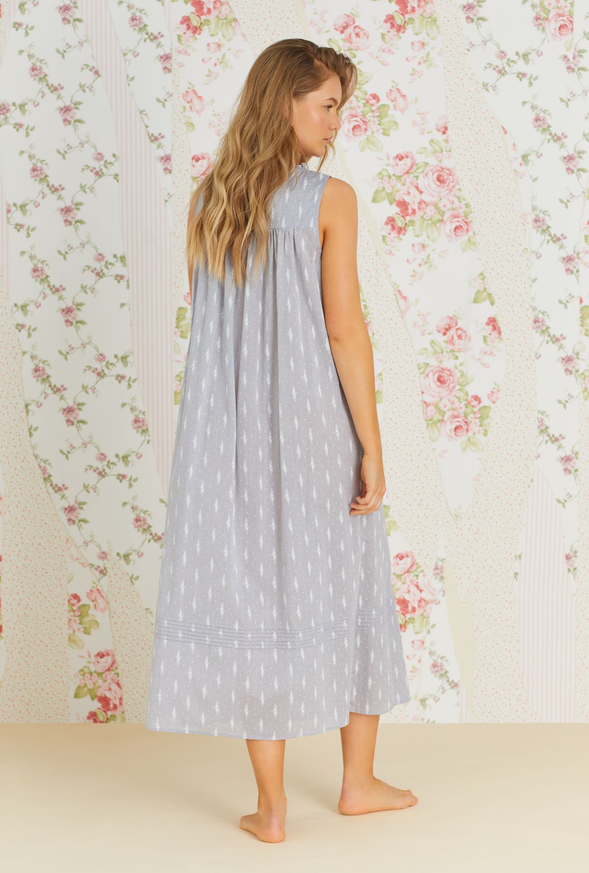A lady wearing grey sleeveless cotton nightgown with chambray floral print.