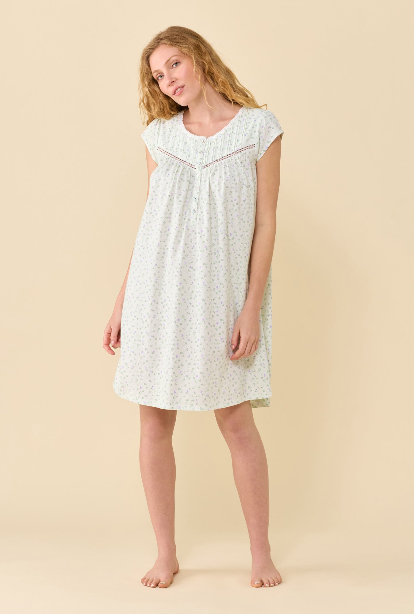 A Lady Wearing Sage Posy Chemise in a front view pose while head tilted gently to her right