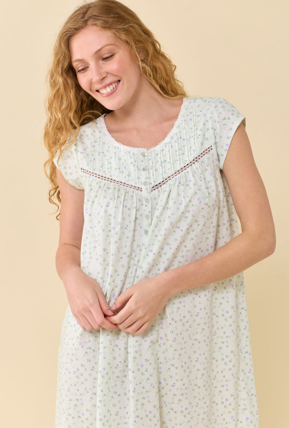 A Lady Wearing Sage Posy Chemise in a front view close up shot with a smile on her face