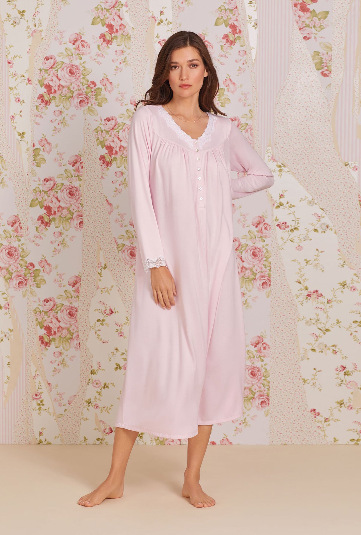 A lady wearing soft pink long sleeve dreamy sweater knit nightgown. 