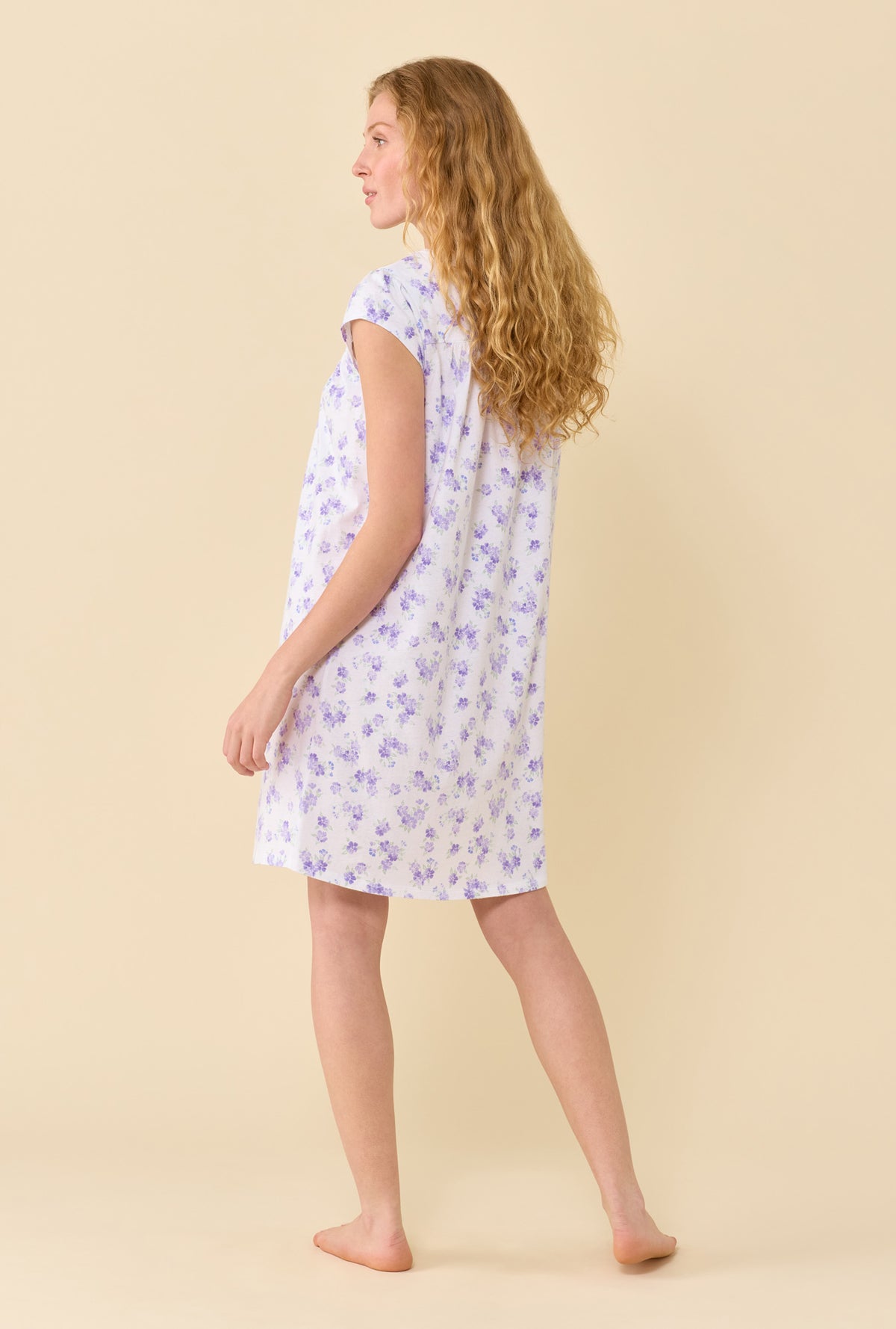 A Lady Wearing Garden Blossom Chemise in a back view pose slightly turned to the side