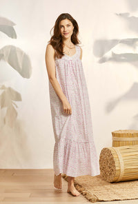 A lady wearing pink sleeveless elizabeth cotton nightgown with vintage rosette print.