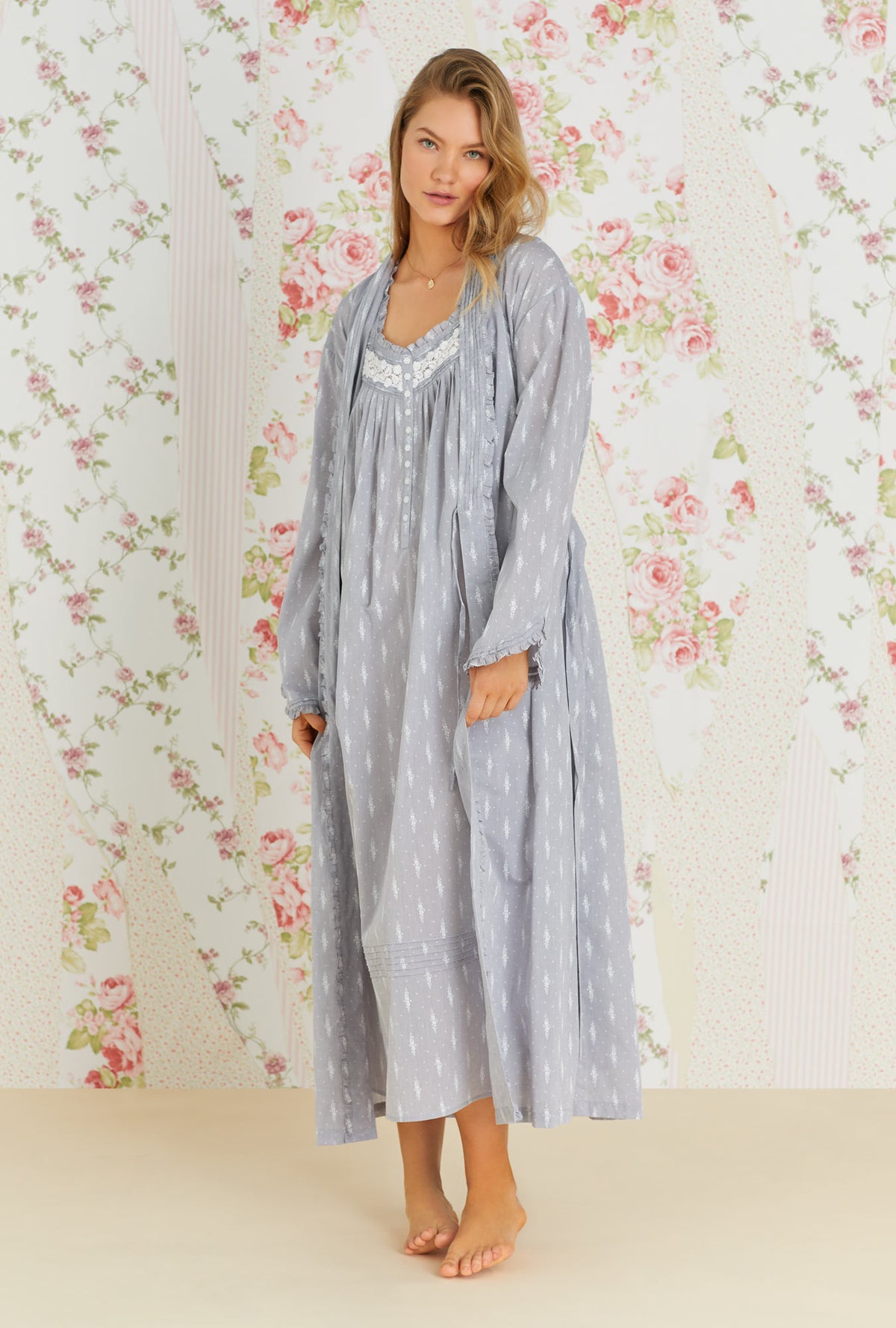A lady wearing grey long sleeve long wrap robe with chambray floral print.