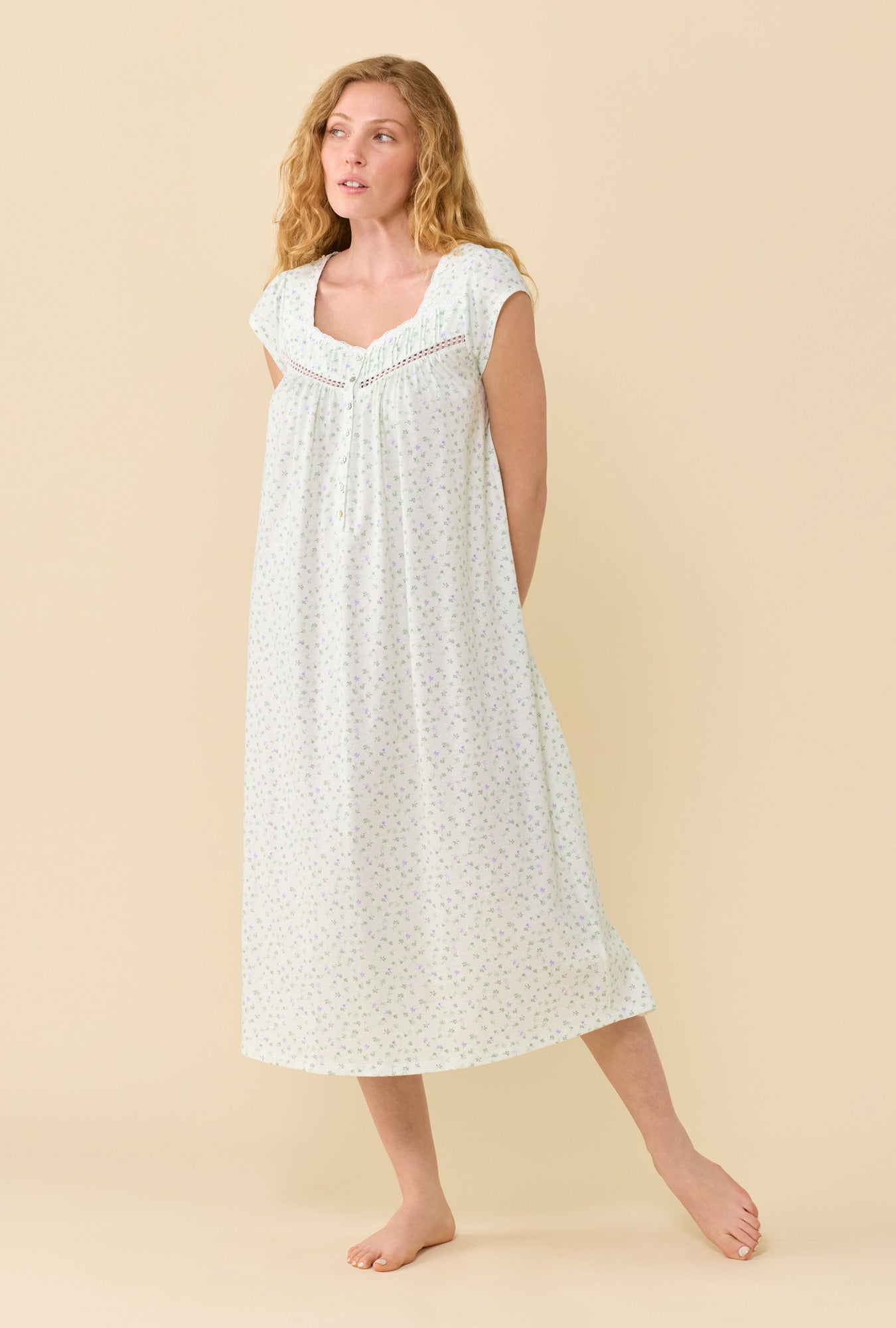 A Lady Wearing Sage Posy Nightgown in a front facing pose while looking to the side