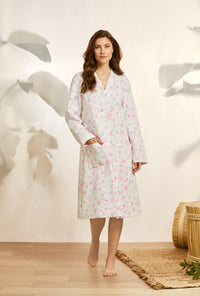 A lady wearing pink long sleeve diamond quilt waltz zip robe with wildflower print.