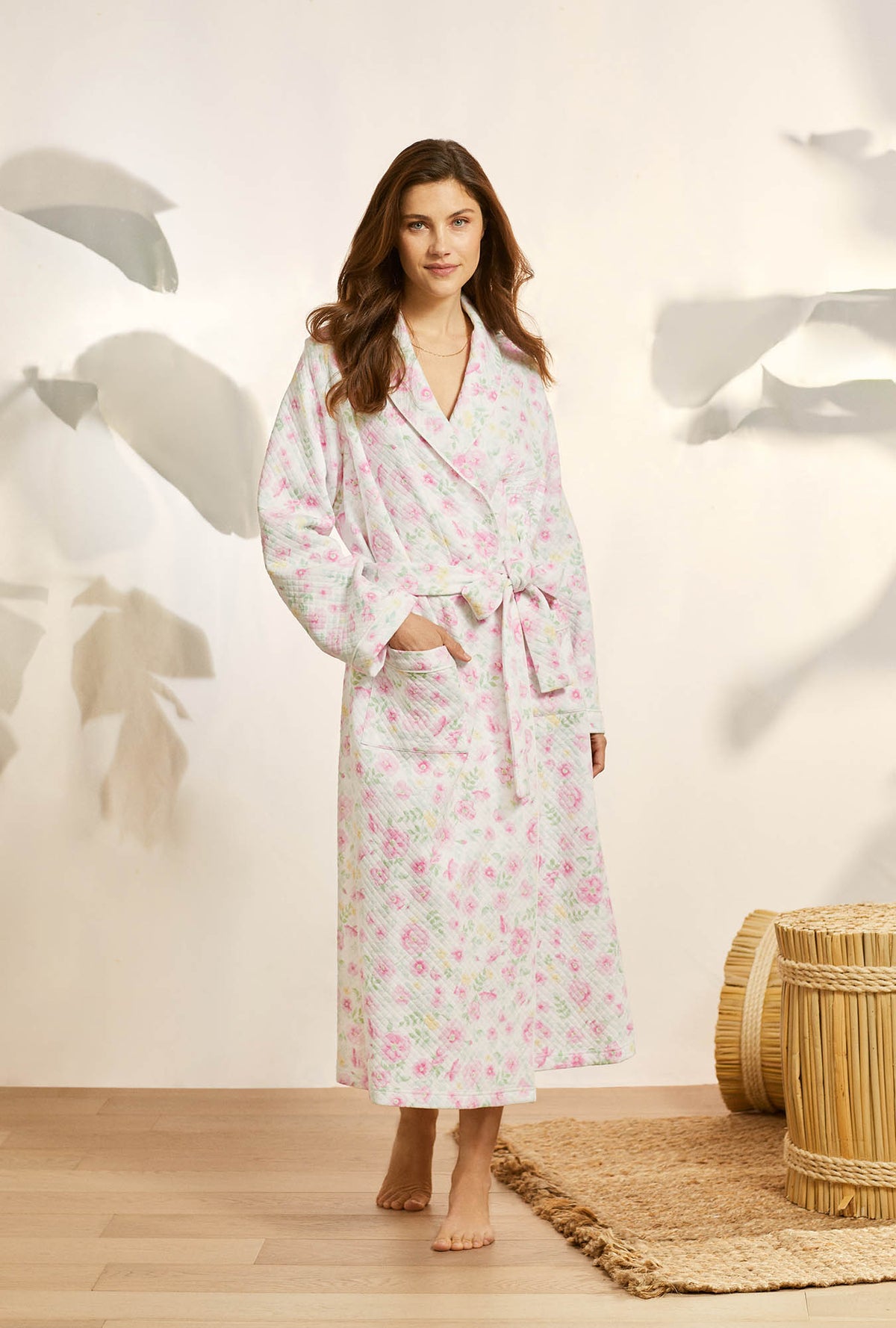 A lady wearing pink long sleeve diamond quilt wrap robe with wildflower print.
