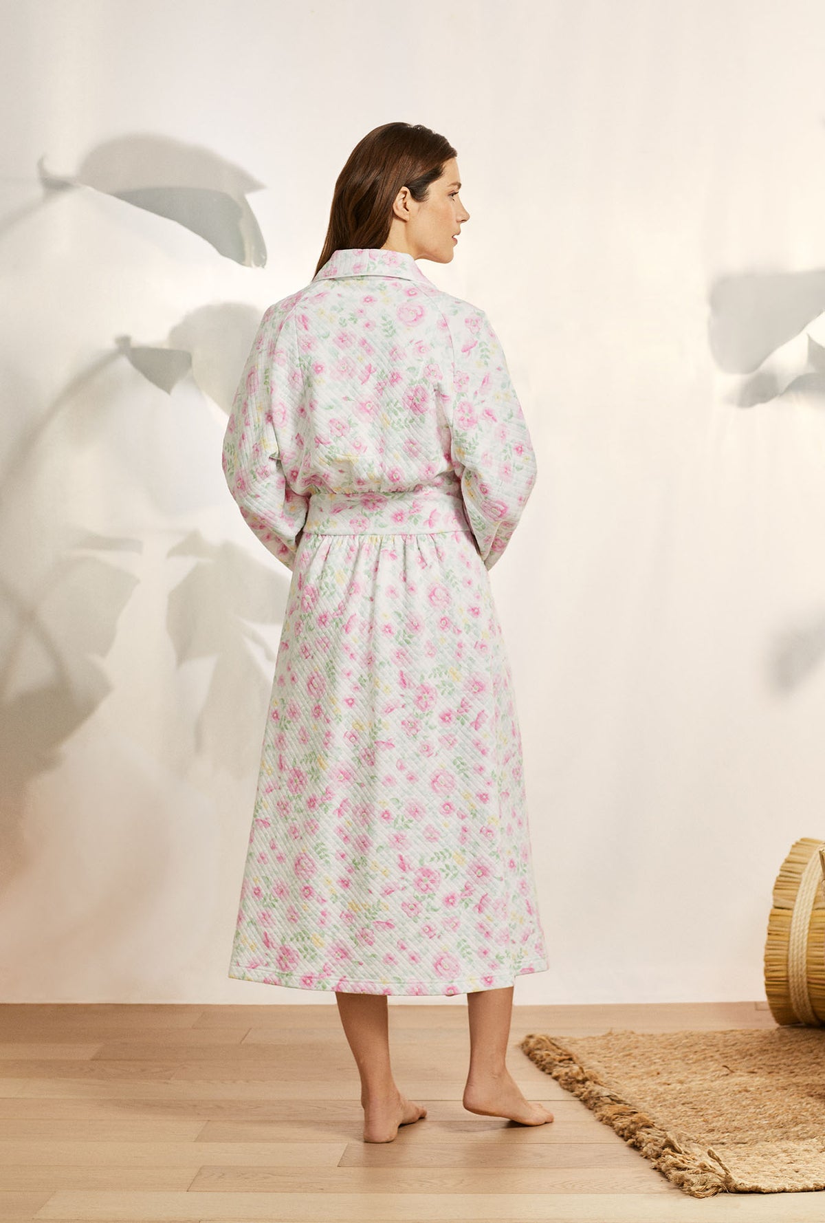 A lady wearing pink long sleeve diamond quilt wrap robe with wildflower print.