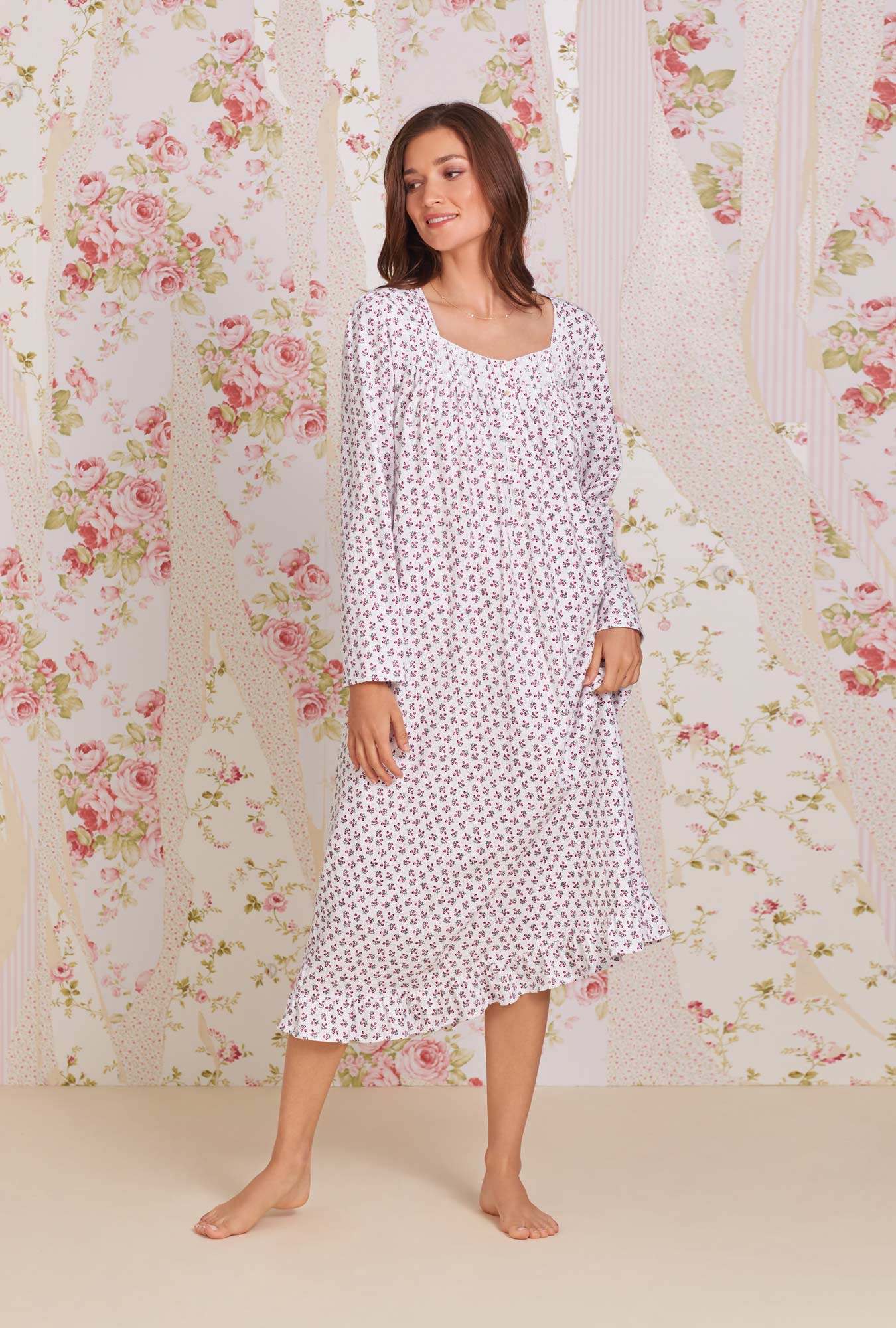 A lady wearing white long sleeve jersey cotton knit  long nightgown with holiday berries peached print.