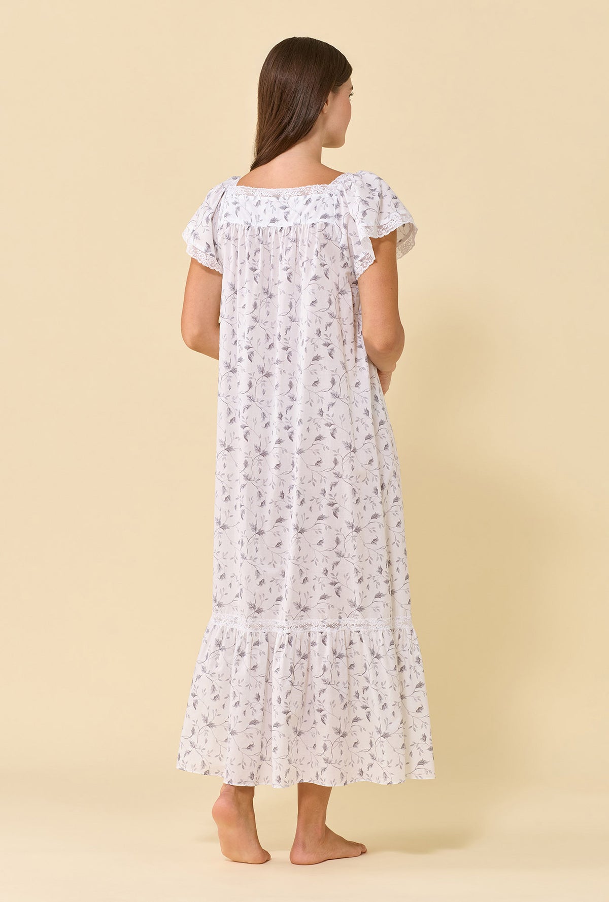 A lady wearing Grace Silver Willow 100% Cotton Woven Lawn Flutter Sleeve Ballet Nightgown back view