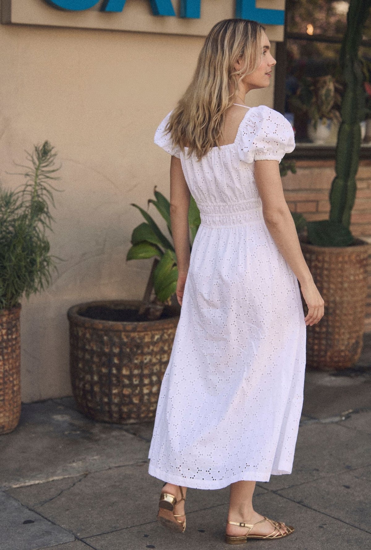 A lady wearing The "Catalina" Soft White Cotton Maxi Dress back view