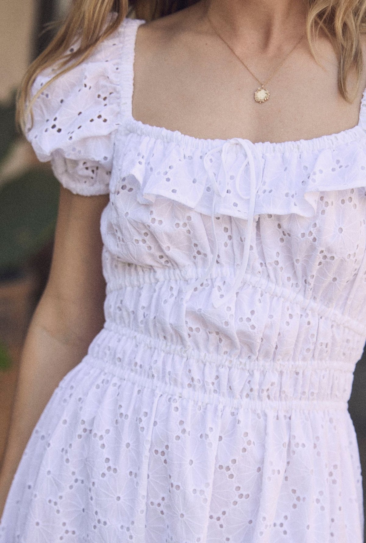 A lady wearing The "Catalina" Soft White Cotton Maxi Dress closer look at front top