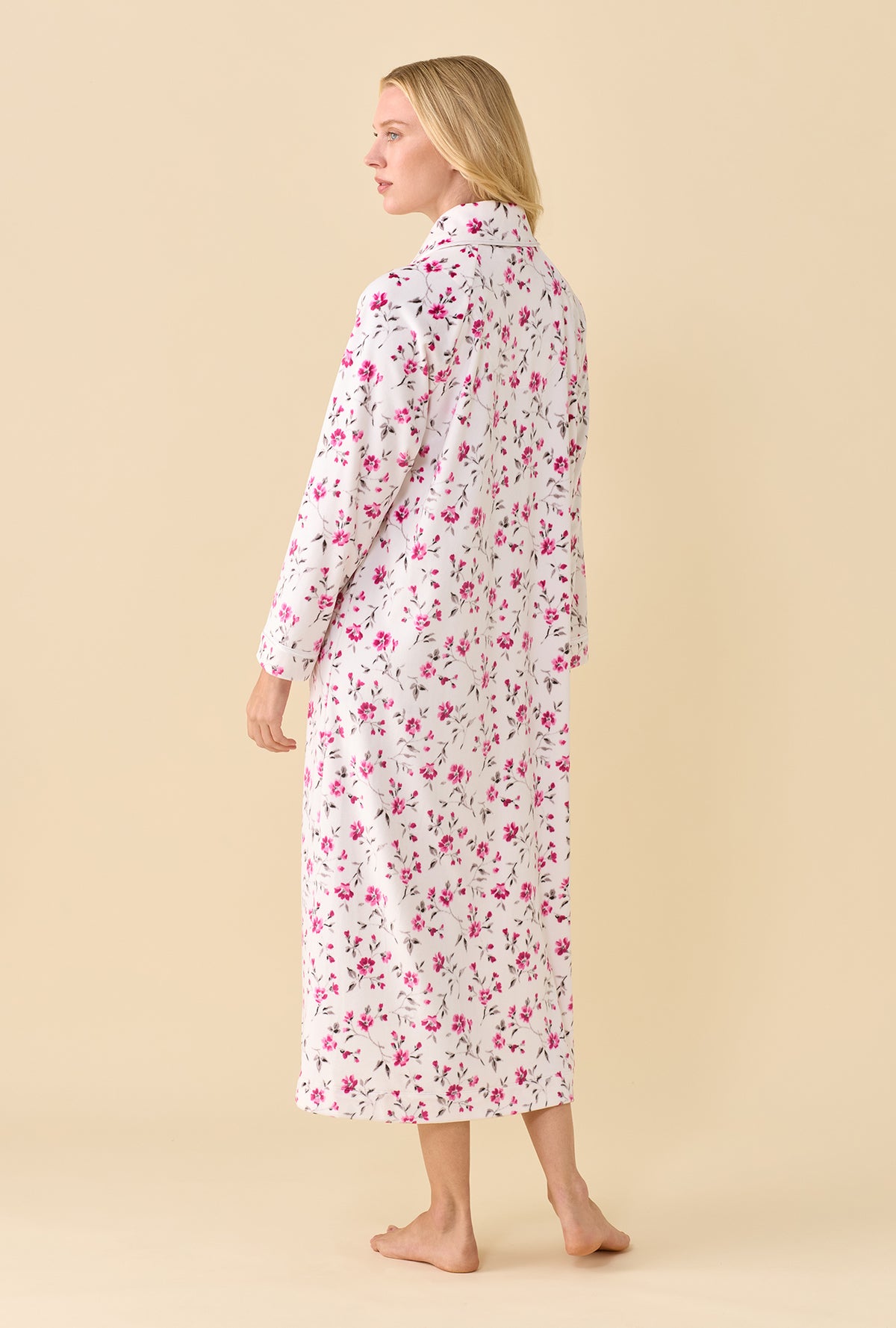 A lady wearing Lux Velour Ballet Zip Robe back view at an angle showing the pink floral print and straight hem