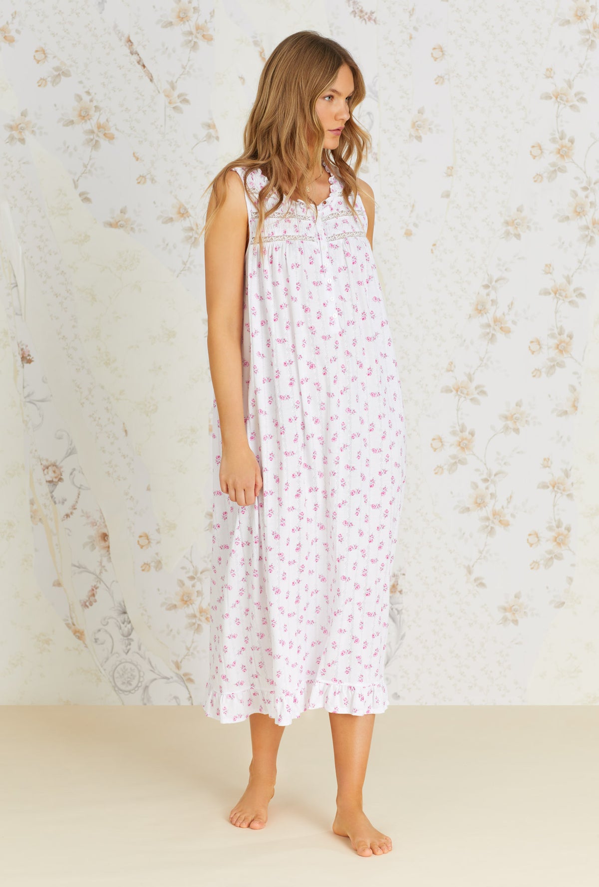 A lady wearing white sleeveless nursing nightgown with vintage rose pointelle print.