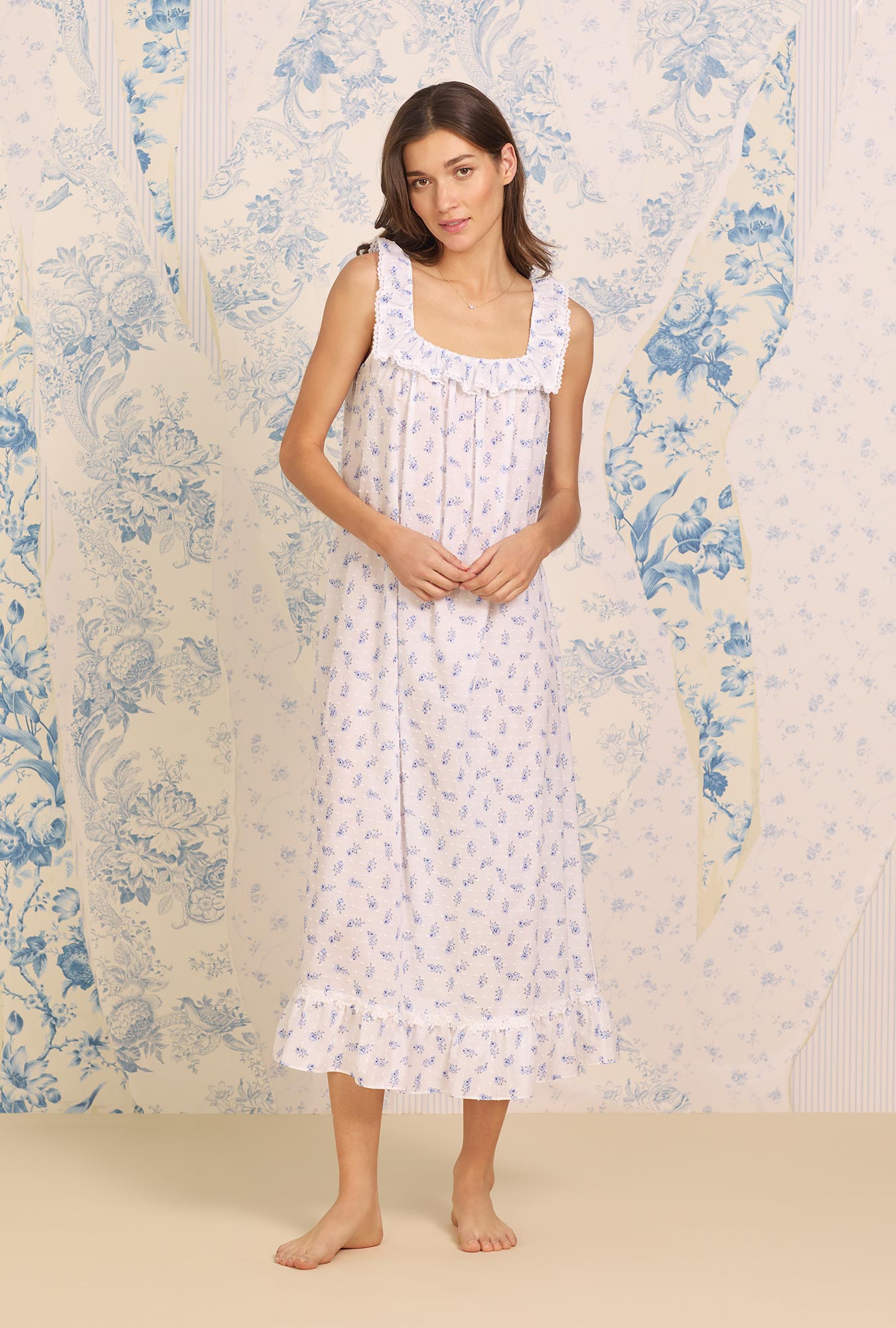 A lady wearing white sleeveless Navy Floral Cotton Ruffle Nightgown with Swiss Dot print