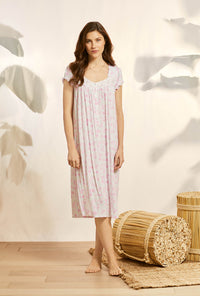 A lady wearing pink cap sleeve knit waltz nightgown with tencel rosey daydream print.