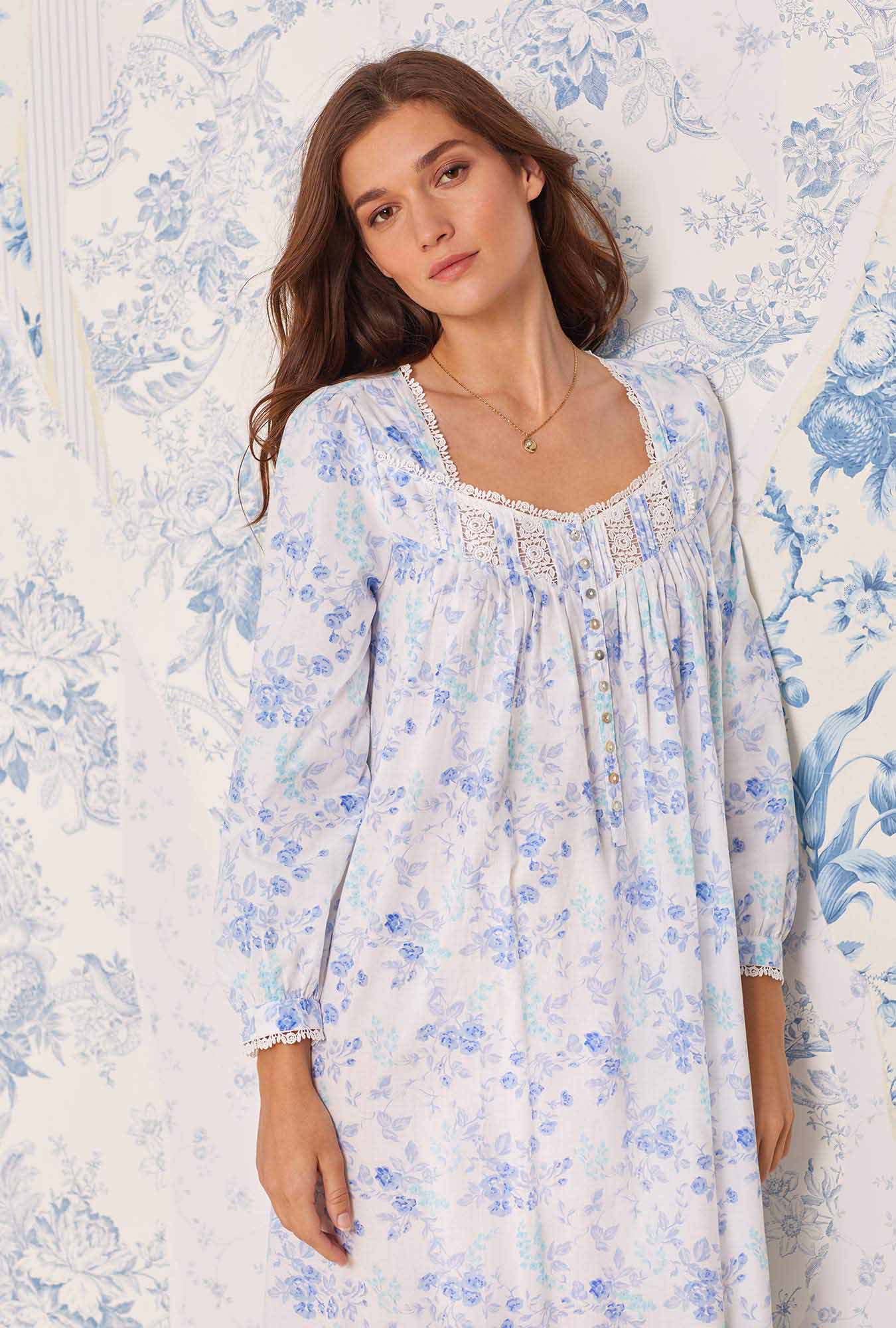 A lady wearing white nightgown with blue floral print