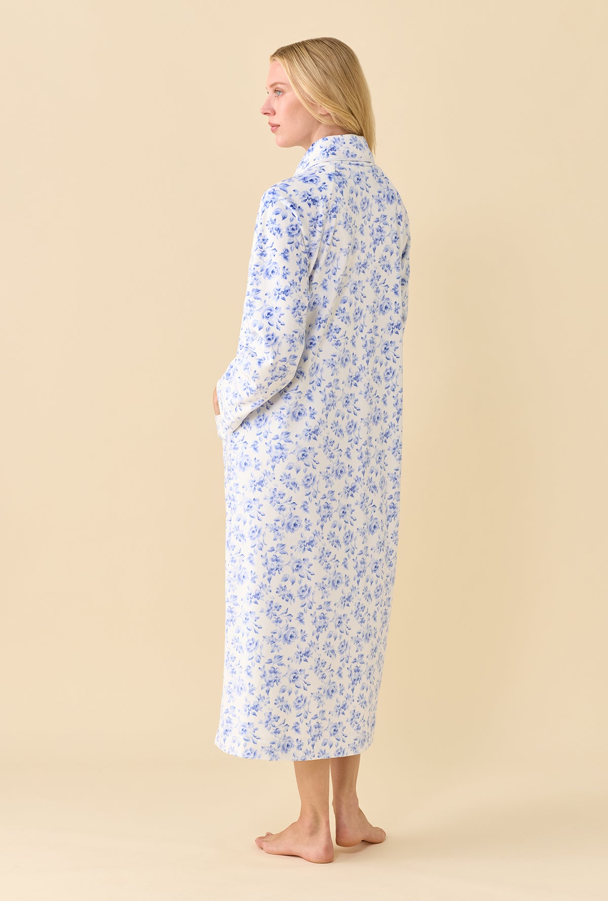A lady wearing Lux Velour Ballet Zip Robe back view at an angle showing the blue floral print