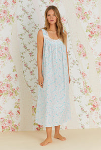 A lady wearing white sleeveless eileen cotton nightgown with tuolumne meadow print.