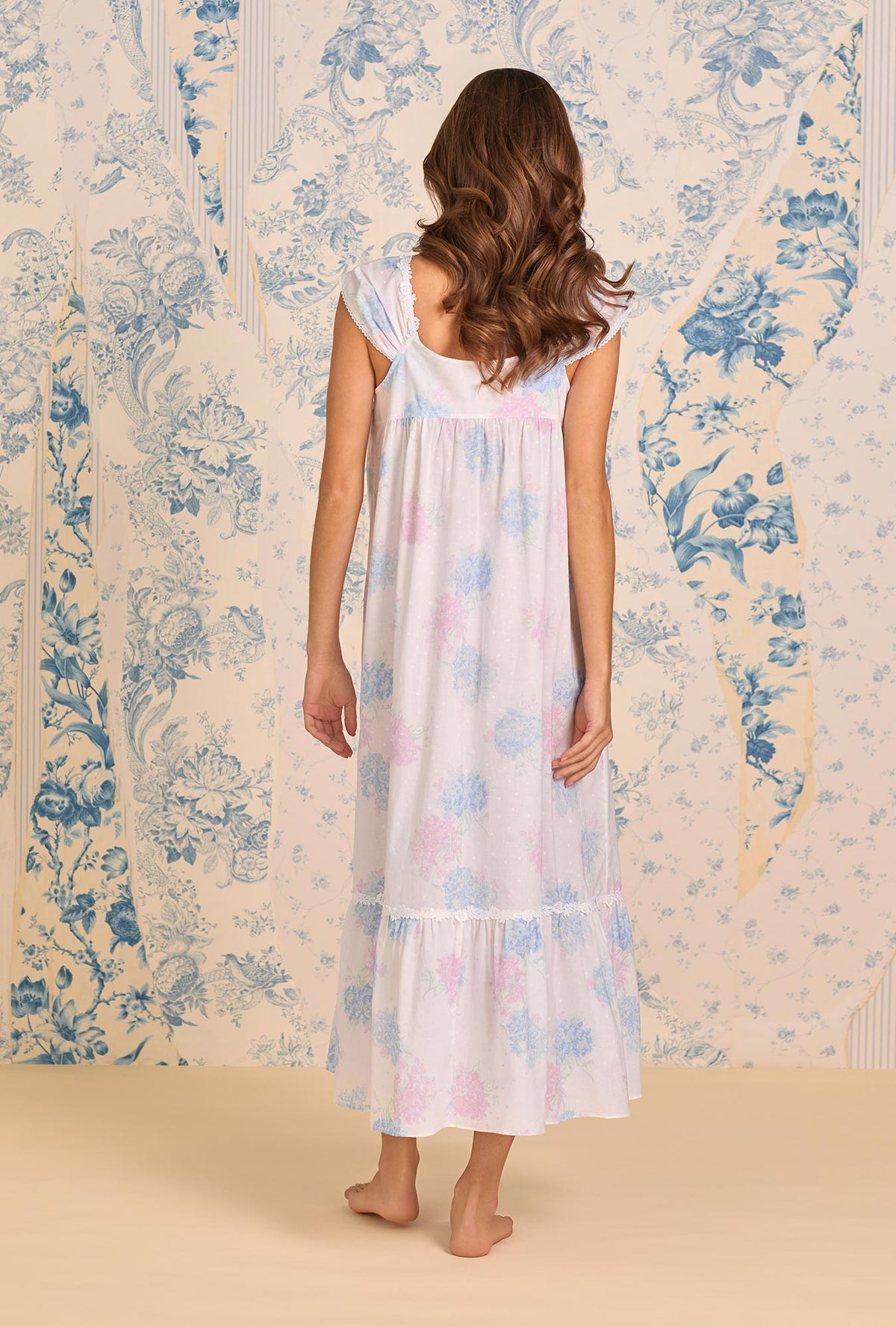 A lady wearing The "Taylor" Hydrangea Blossom Cotton Lawn Ballet Nightgown back view