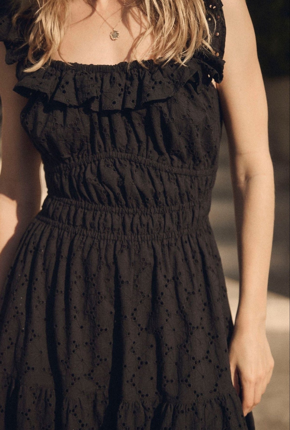 A lady wearing The "Isla" Iconic Black Cotton Maxi Dress closer look