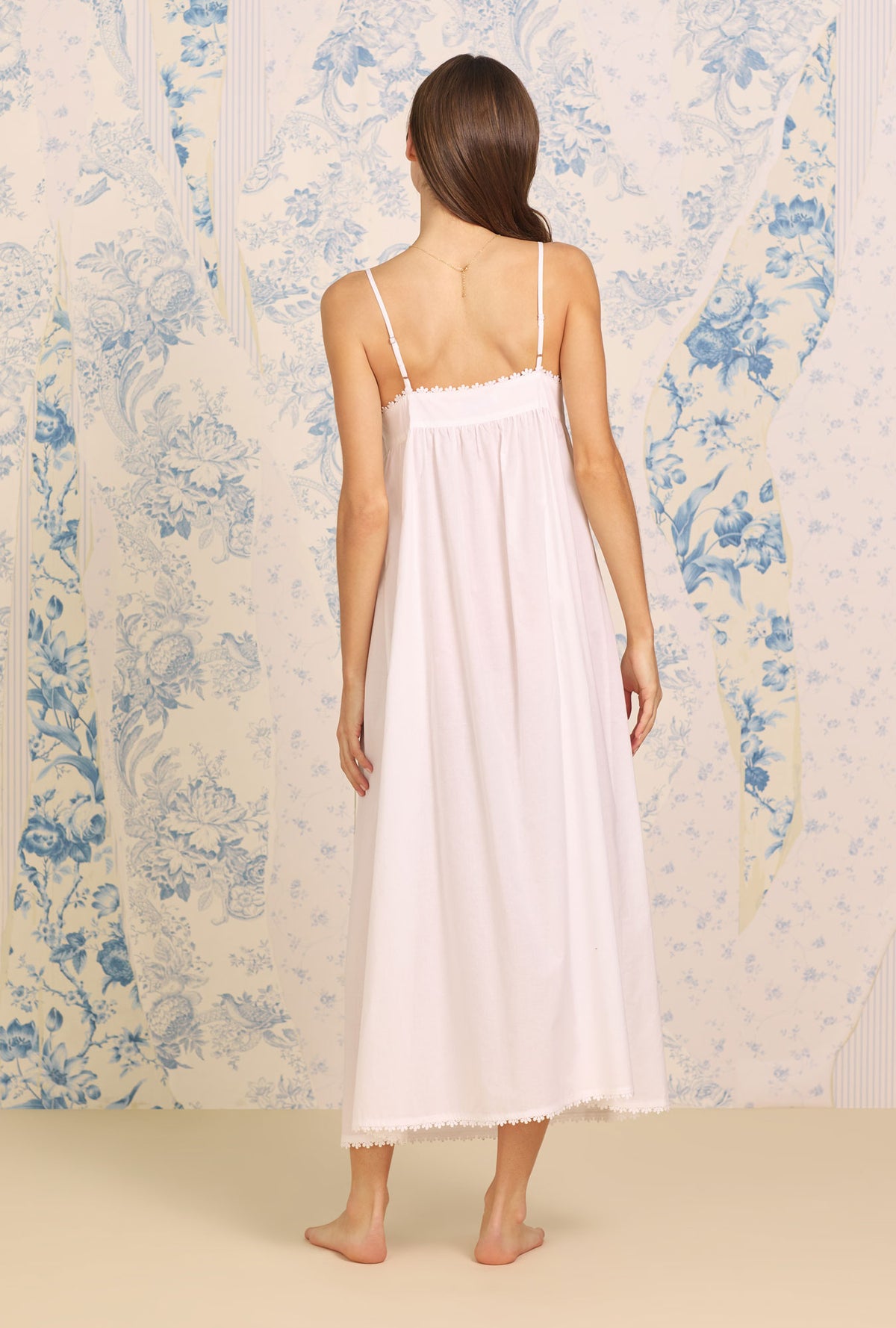 A lady wearing white sleeveless Samantha&quot; Cotton Nightgown with Dune Beach Embroidered print