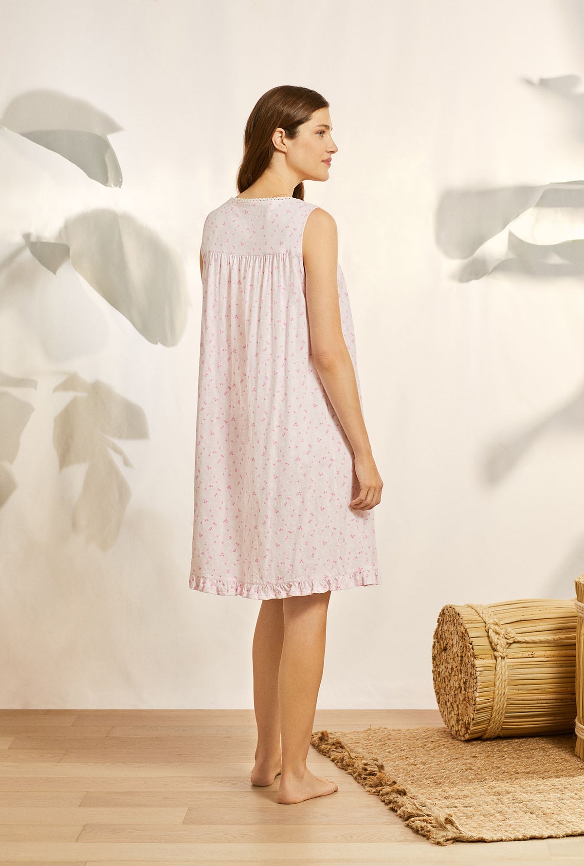 A lady wearing pink sleeveless cotton knit nightgown with blushing pink floral print.