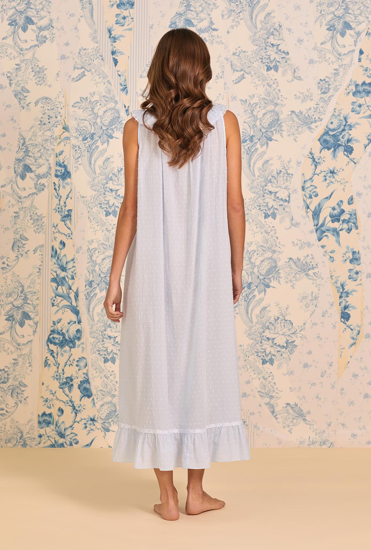 A lady wearing The "Rosalie" Sky Blue Cotton Swiss Dot Ballet Nightgown back view