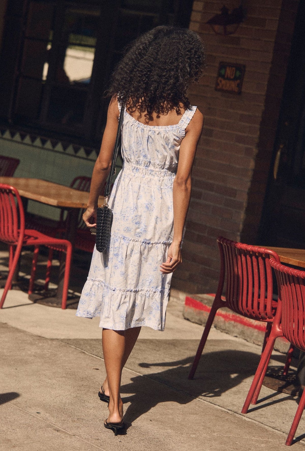A lady wearing The "Nora" Coastal Toile Cotton Midi Dress back view