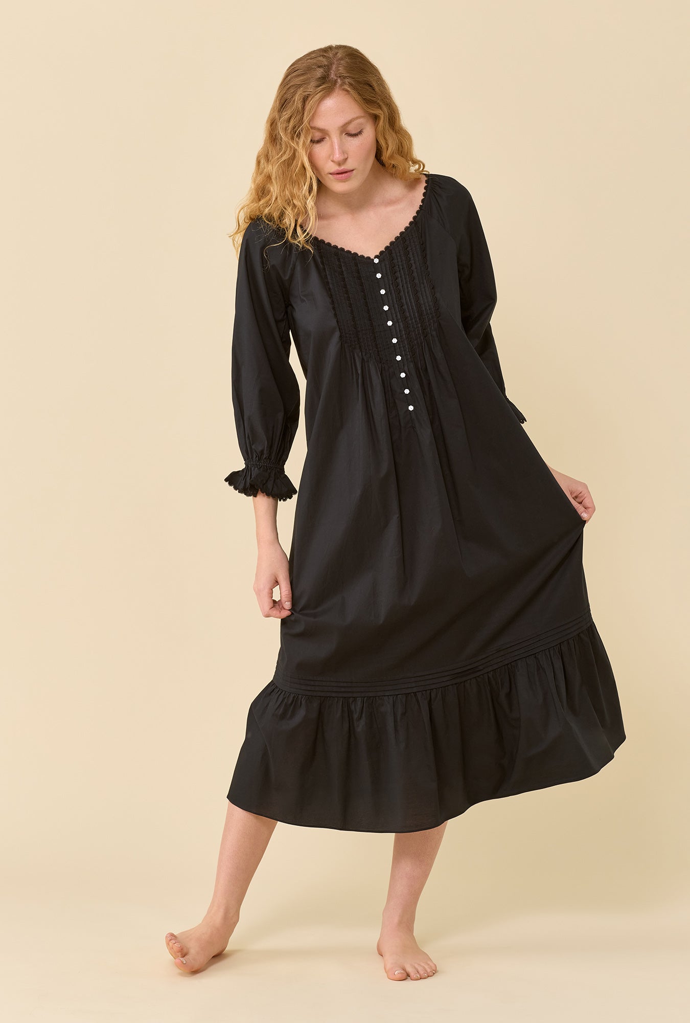 A lady wearing Faye Iconic Black 100% Cotton Woven Lawn 3/4 Sleeve Ballet Nightgown looking down