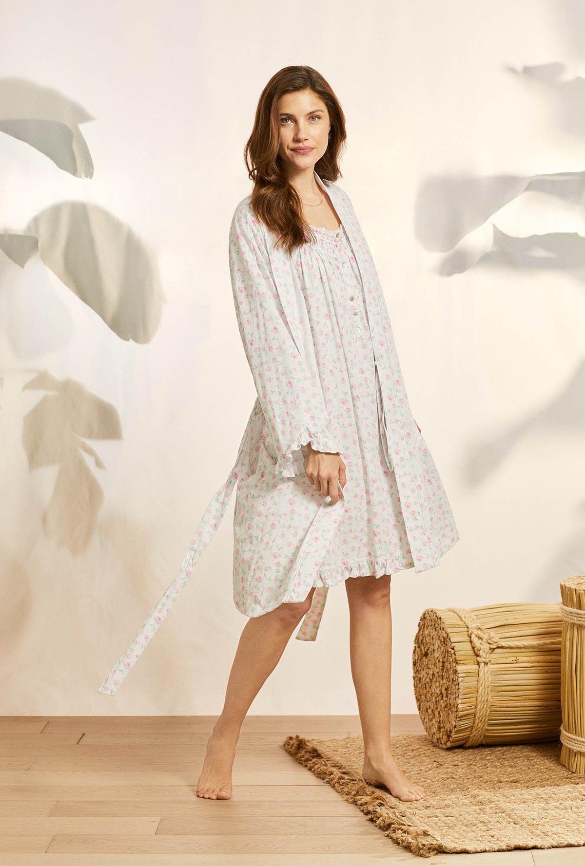 A lady wearing white long sleeve cotton knit short wrap robe with petal dreams.