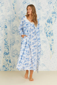 A lady wearing long sleeve french toile cotton woven long button front robe.