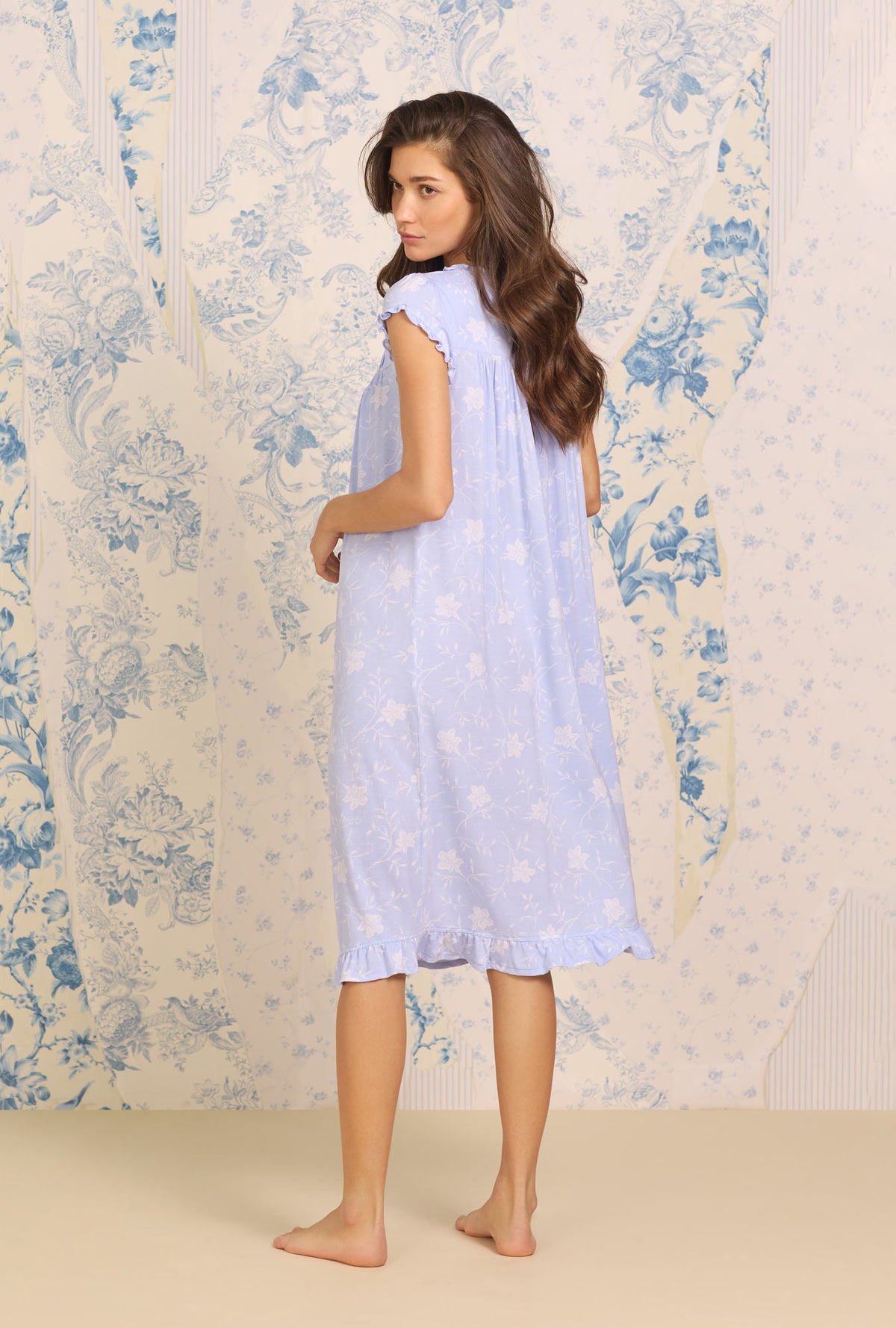 A lady wearing blue sleeveless Sapphire Floral Waltz Nightgown  with Tencel Maritime print 