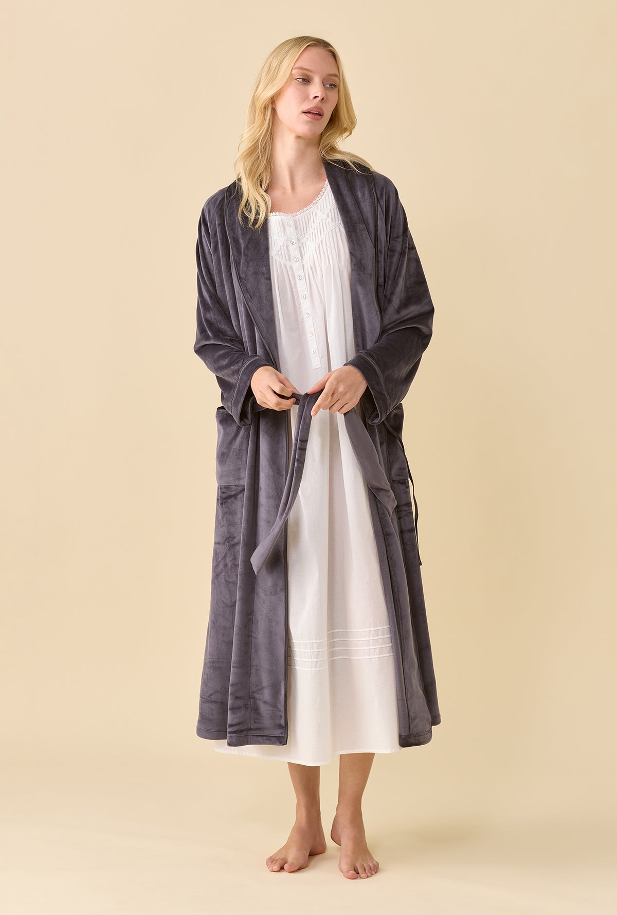 A lady wearing Lux Velour Long Wrap Robe open over a white nightgown front view holding the untied belt