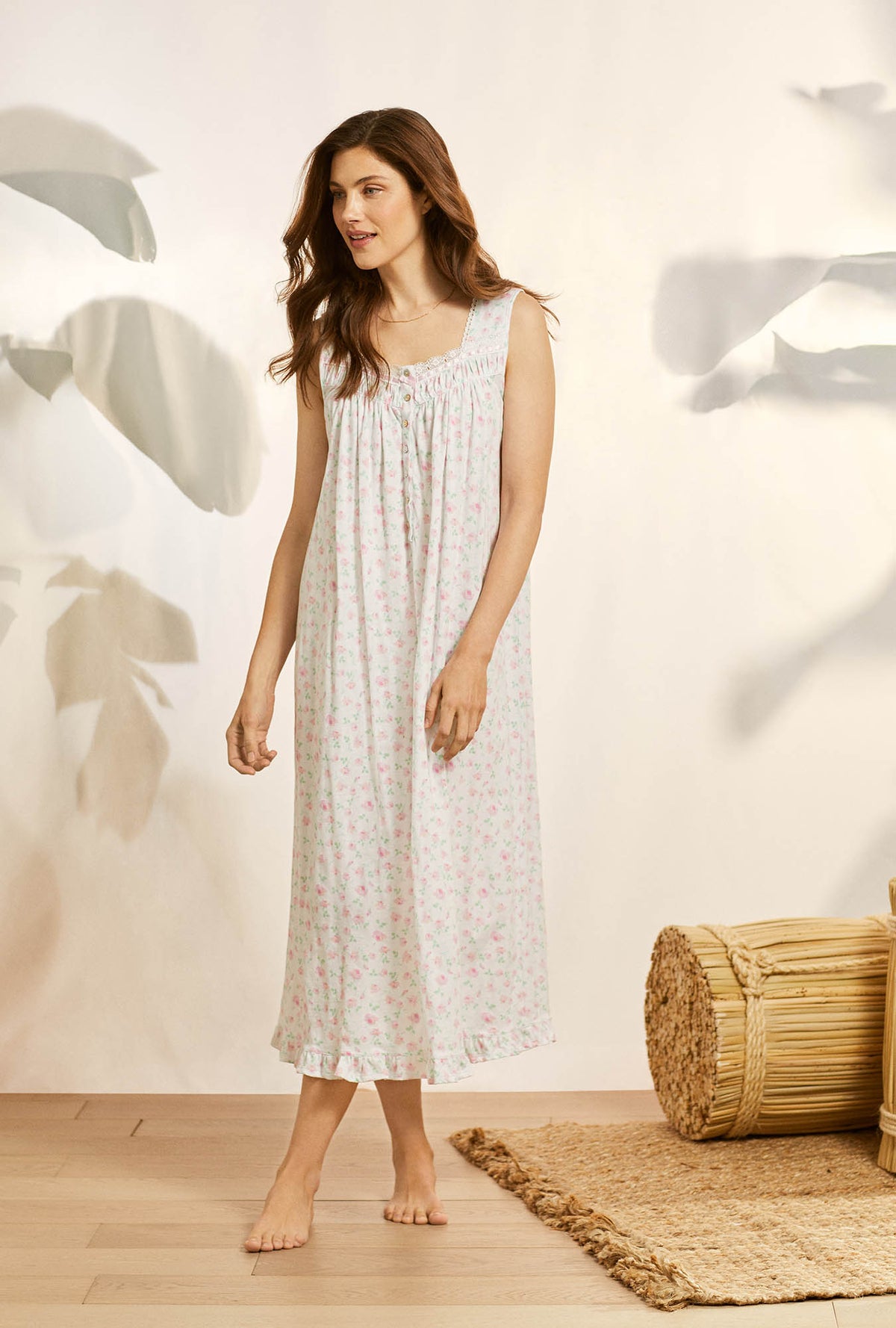 A lady wearing white sleeveless cotton knit long nightgown with petal dreams.
