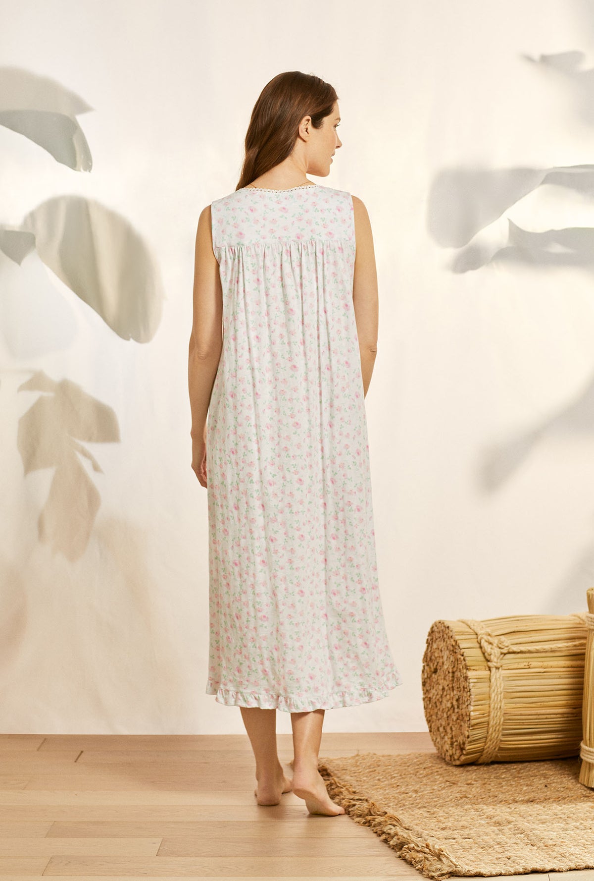 A lady wearing white sleeveless cotton knit long nightgown with petal dreams.