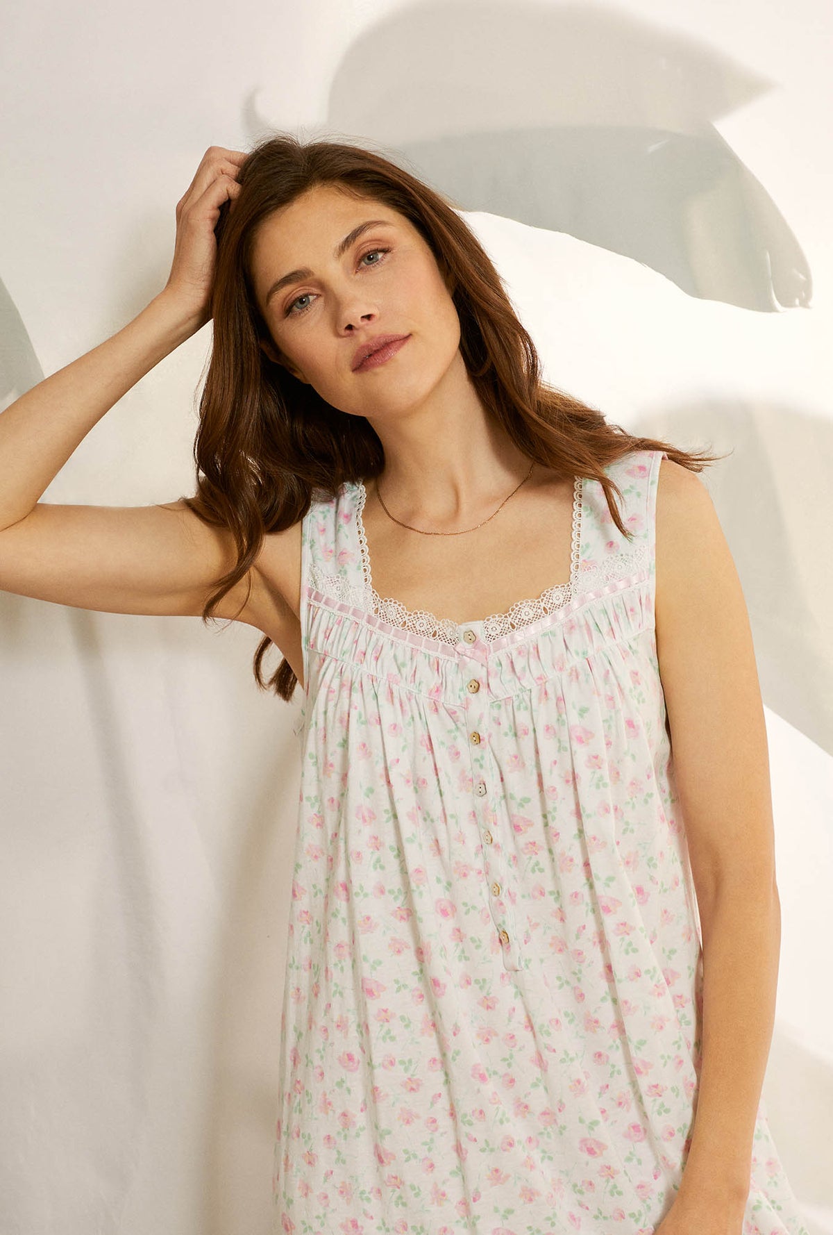 A lady wearing white sleeveless cotton knit long nightgown with petal dreams.