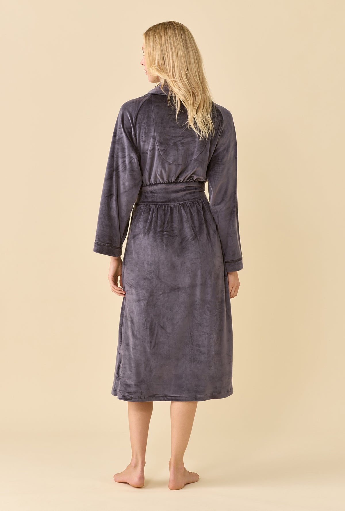A lady wearing Lux Velour Long Wrap Robe back view showing the belt around the waist and straight hem