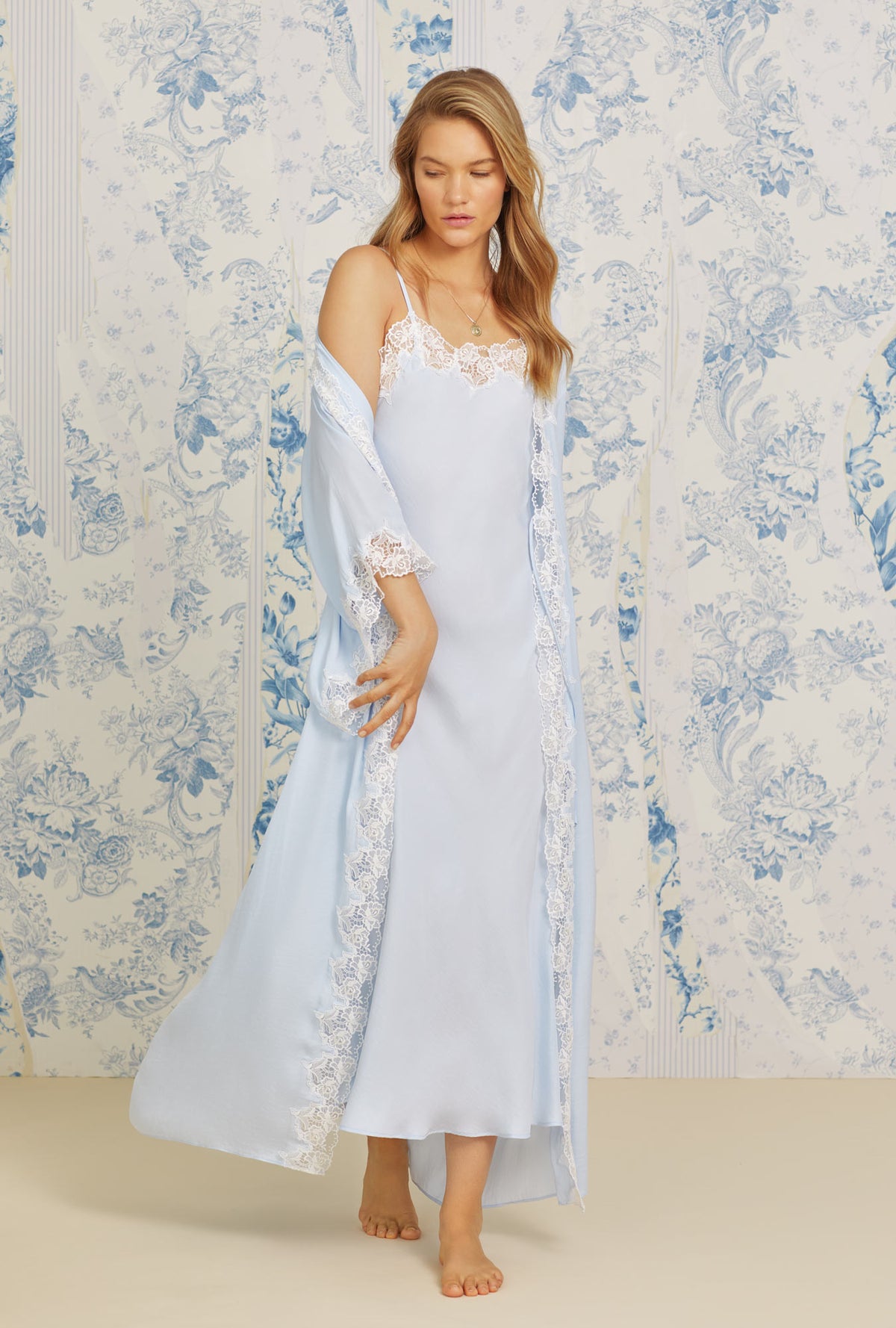 A lady wearing blue quarter sleeve satorini satin wrap robe.