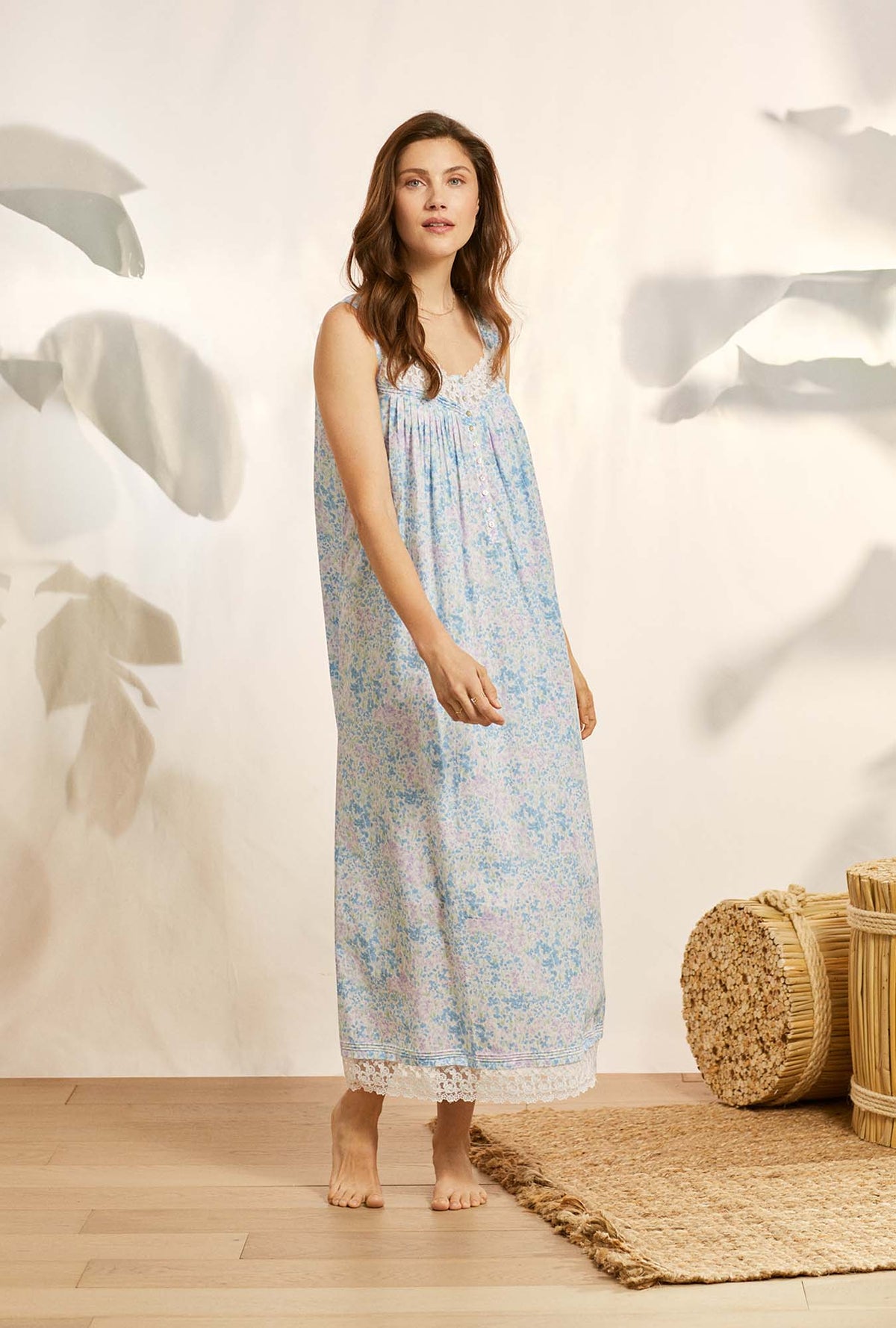A lady wearing blue sleeveless eileen cotton nightgown with montara fields print.