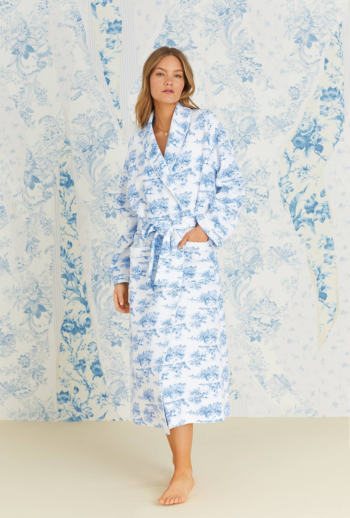 A lady wearing long sleeve french toile diamond quilt long wrap robe.