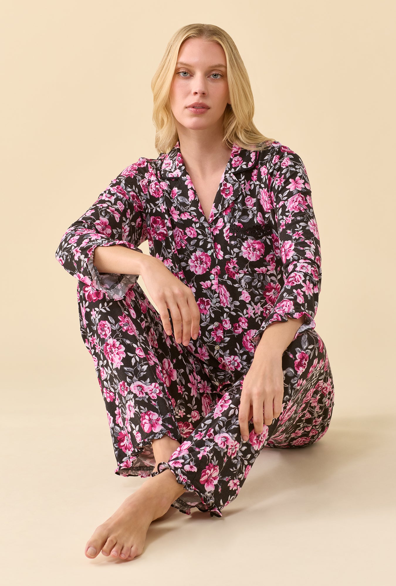 A lady wearing Midnight Briar TENCEL™ Modal Spandex Jersey Knit Long Sleeve Pajama Set sitting down