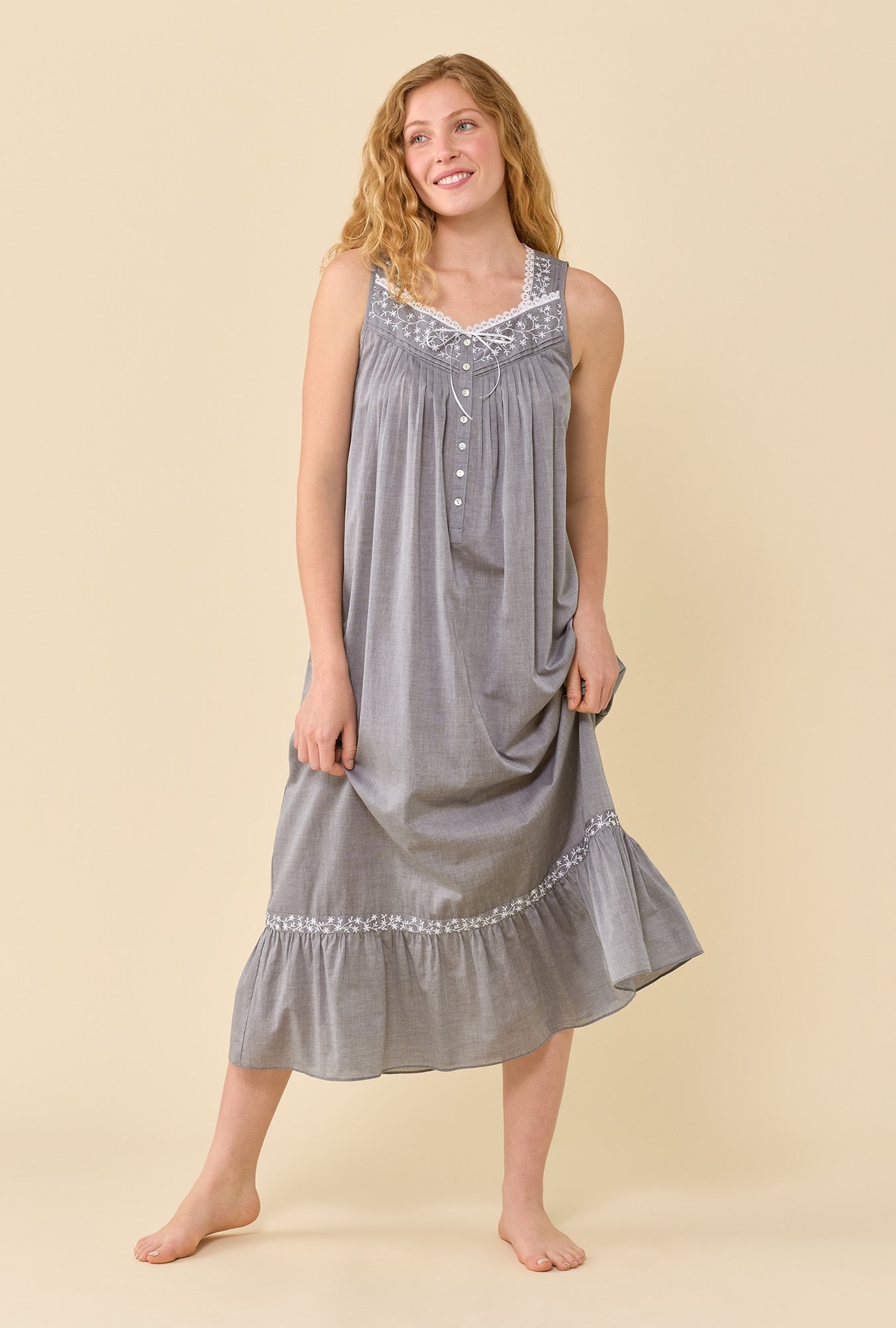 A lady wearing Eileen Moonlight 100% Cotton Yarndye Chambray Ballet Nightgown looking up