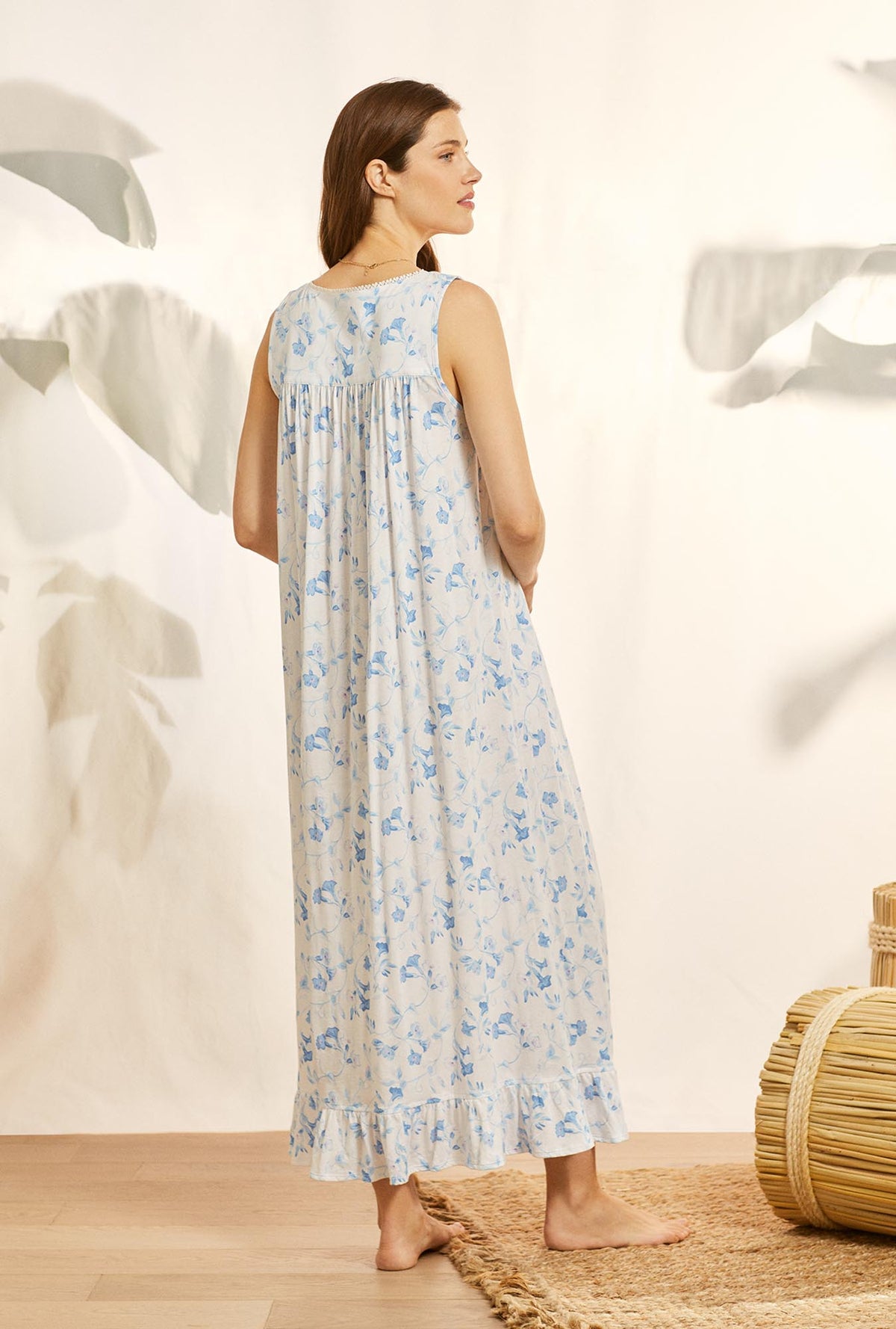 A lady wearing blue knit eileen nightgown with morning glory print.