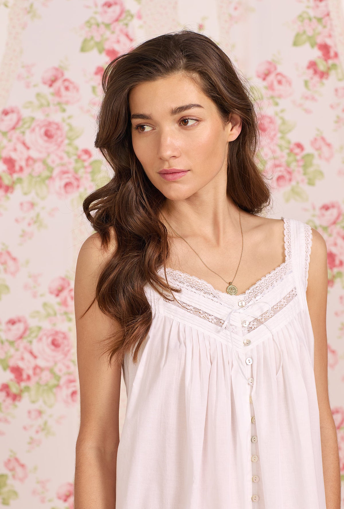   A lady wearing white sleeveless Classic White Nightgown with the rosalie print