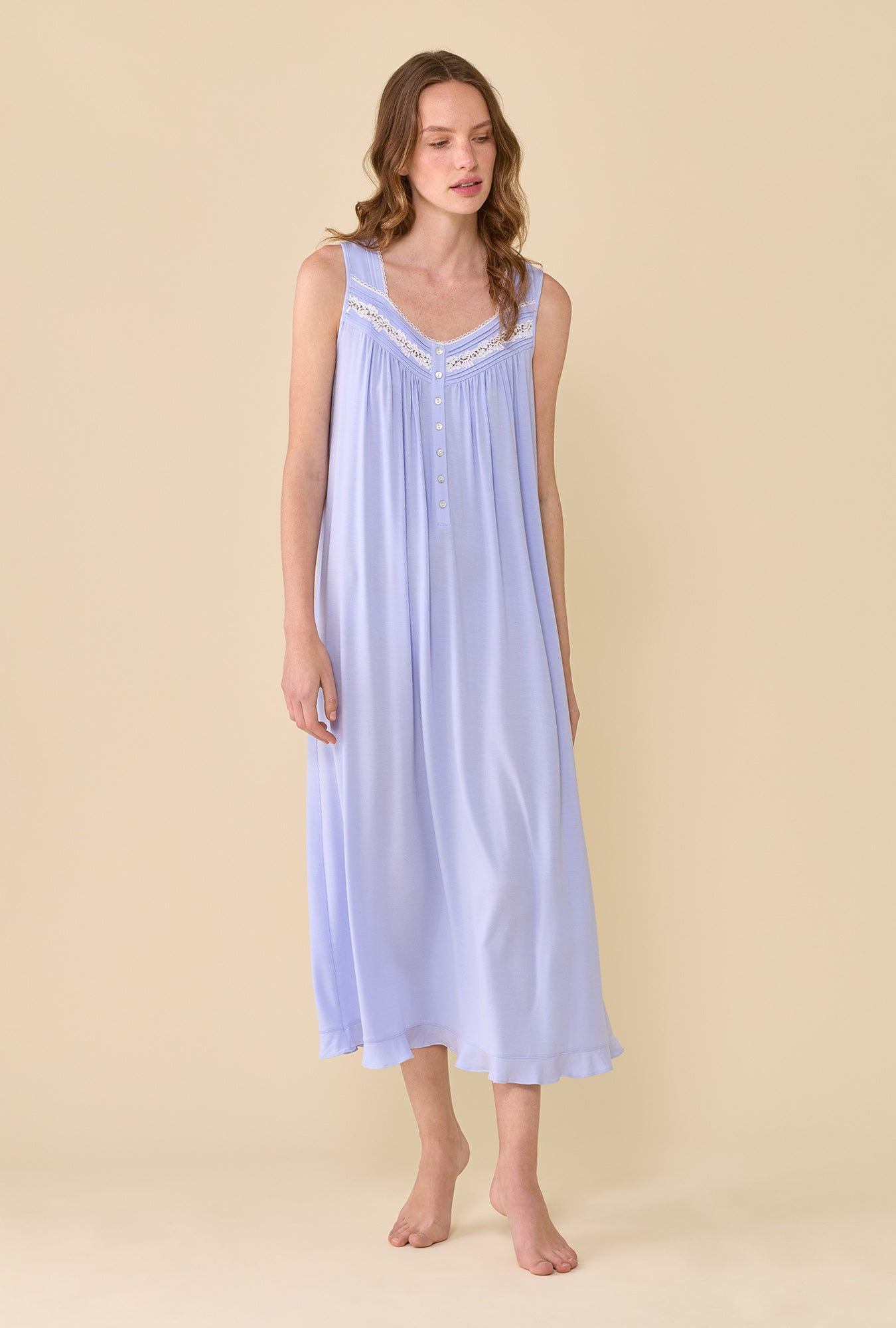A lady wearing The Eileen Peri Nightgown looking down