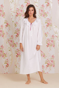 A lady wearing white long sleeve clara poet nightdress.