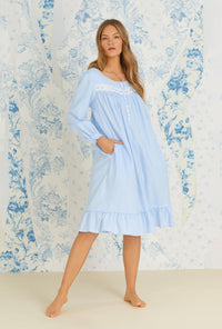 A lady wearing long sleeve dream blue rayon cotton flannel waltz nightgown.