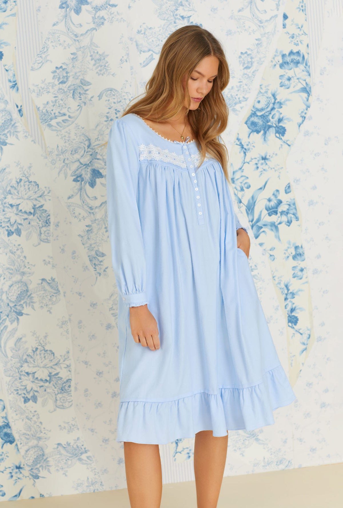 A lady wearing long sleeve dream blue rayon cotton flannel waltz nightgown.