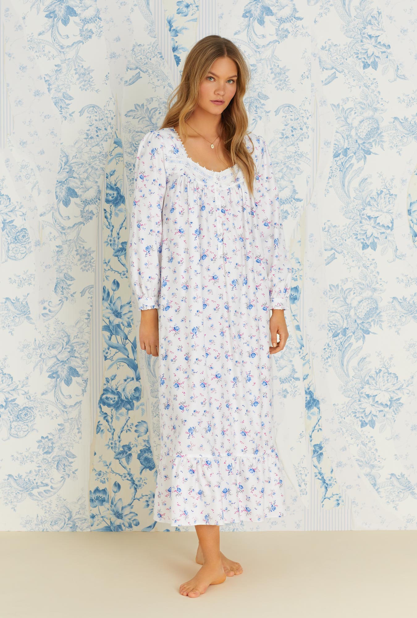 A lady wearing long sleeve rose and berry floral rayon cotton flannel long nightgown.